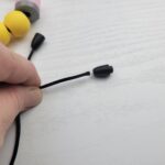 inserting a cord into one side of the clasp.